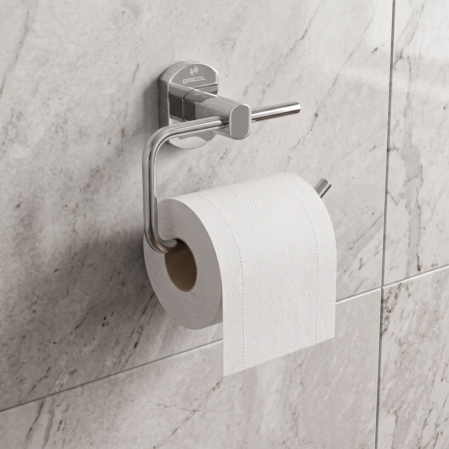 Portarrollo metálico Portobello para baño GRICOL en acabado cromado instalado en la pared de un baño, con papel higiénico.